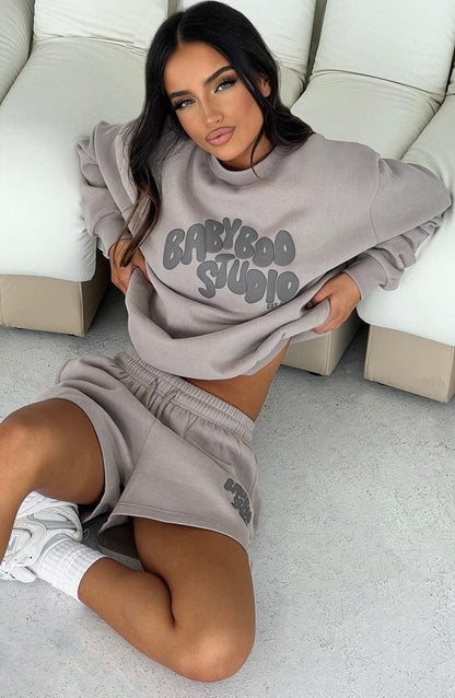 https://cdn.shopify.com/s/files/1/2060/7491/files/studio-sweater-mocha-charcoal-tops-xs-s-babyboo-fashion-31198185193535.jpg?v=1748603285